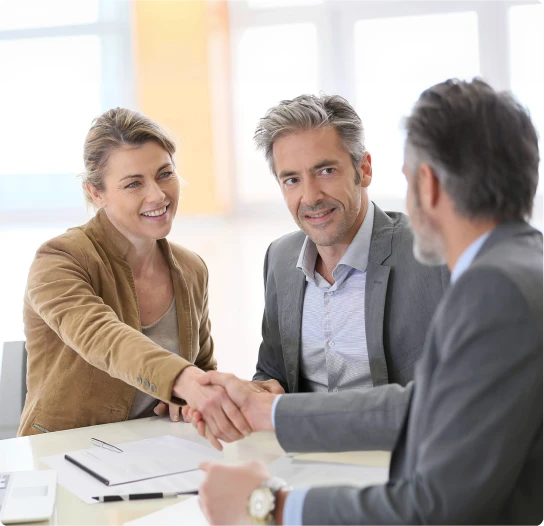 Clients shaking hands with a mortgage broker after securing a home loan through Mamba Capital Lending mortgage broker services.