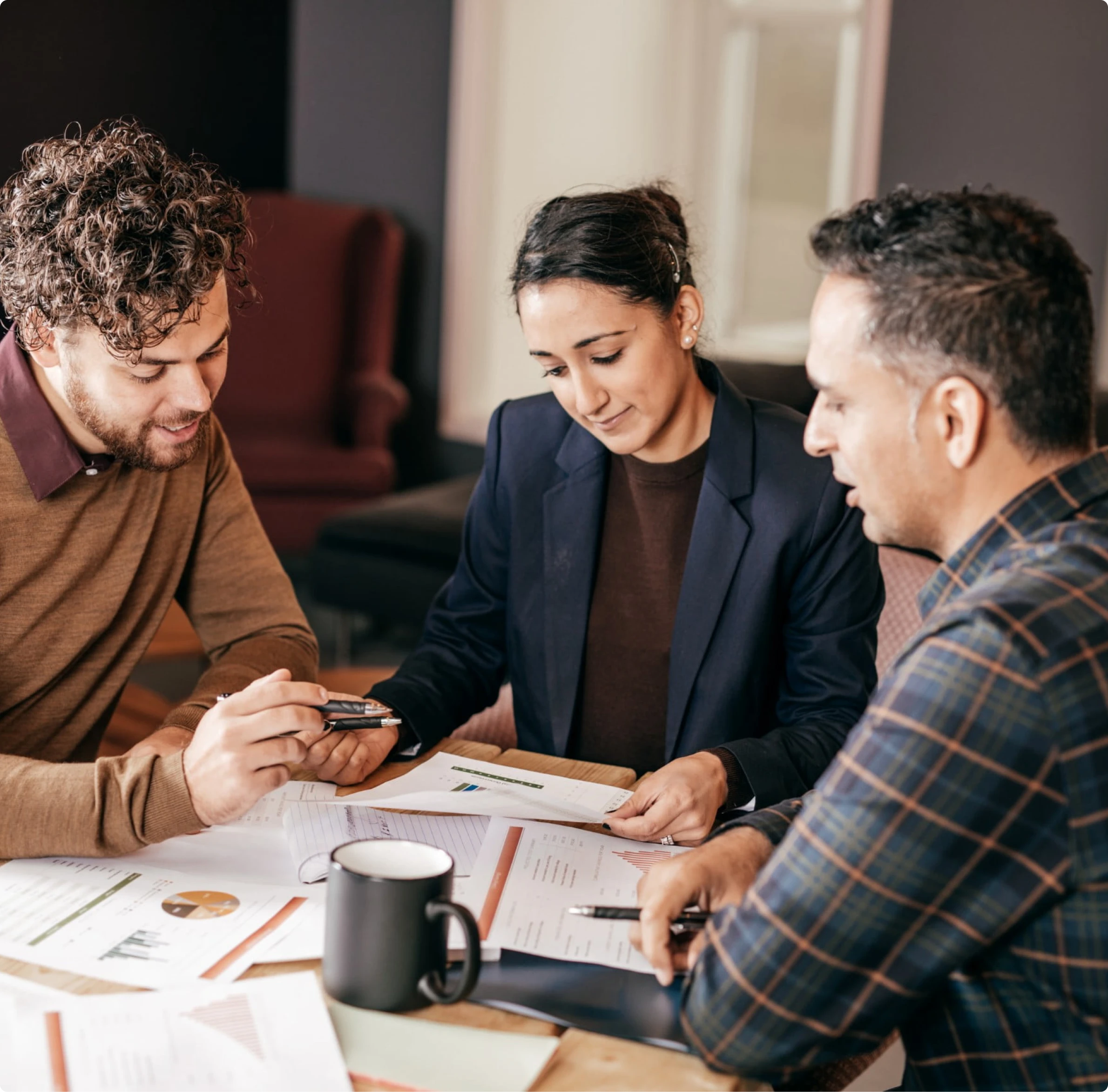 Mortgage professionals reviewing loan documents and discussing home loan financing solutions with guidance from Mamba Capital Lending mortgage broker services.